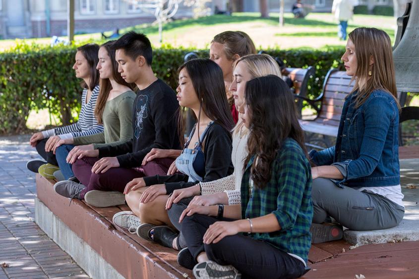 Students meditating on campus.